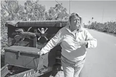  ??  ?? Second row, left
Lenore Baker stands Friday with the trailer she uses to help clean debris on Big Pine Key in the Florida Keys. Baker and local volunteers help remove debris from the roadside, trying to return the neighborho­od to normal.