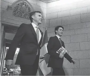  ?? SEAN KILPATRICK / THE CANADIAN PRESS FILES ?? Finance Minister Bill Morneau, left, and Prime Minister Justin Trudeau continue to say they will stick to their spending plan rather than tighten fiscal policy.