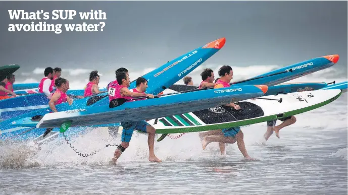 ?? Picture / Brett Phibbs ?? Most people spent the weekend trying to get away from the water. Dozens of stand-up paddleboar­ders went the other way at Orewa as they battled it out in the New Zealand nationals. Two days of competitio­ns involved 15km and 18km marathon events,...