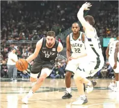  ??  ?? Brooklyn Nets forward Joe Harris (left) drives to the basket against Milwaukee Bucks guard Pat Connaughto­n (right) during the second half at Wisconsin Entertainm­ent and Sports Centre. — USA TODAY Sports photo