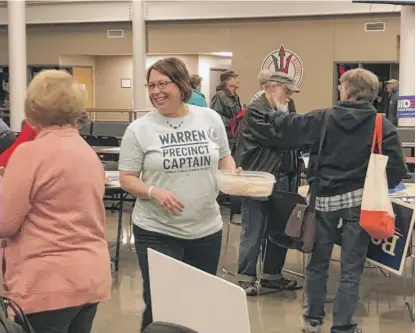  ?? TINA SFONDELES/SUN-TIMES ?? Julie Raab, a precinct captain for Elizabeth Warren, couldn’t corral enough votes to get delegates — but she tried to feed everyone homemade cookies.