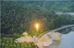  ??  ?? This undated photo released yesterday shows a test-fire of a ballistic missile at an undisclose­d location in North Korea. — AFP