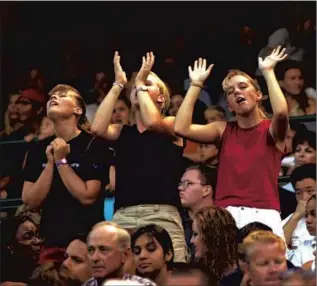  ?? David McNew Getty Images ?? PEOPLE respond to the Christian band Delirious at the Harvest Crusade in Anaheim in 2001.