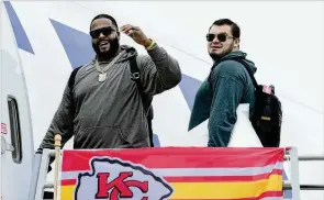  ?? REED HOFFMANN/AP ?? Chiefs tackle Donovan Smith (left) and guard Nick Allegretti board the team’s plane bound for Las Vegas and Super Bowl LVIII. Allegretti will step up for an injured Joe Thuney.