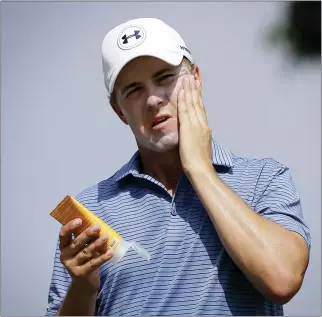  ?? WONG MAYE-E — THE ASSOCIATED PRESS ?? Jordan Spieth applies sunscreen during a recent tournament. Golfers are in the sun as much if not more than players in other sports, and because of that they have a renewed emphasis on protecting their skin.