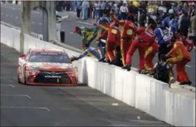  ?? DARRON CUMMINGS — THE ASSOCIATED PRESS ?? Kyle Busch celebrates with his crew after winning the Brickyard 400 on July 24 at Indianapol­is Motor Speedway.