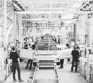  ?? Justin Kaneps / New York Times ?? The Model 3 assembly line tracks in Fremont, Calif. Tesla is reducing its workforce by 7 percent.