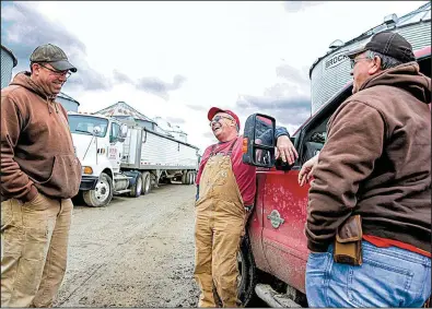  ?? AP/NATI HARNIK ?? Blake Hurst (center) talks with his brothers, Brooks Hurst (left) and Kevin Hurst, on Blake’s farm last month in Westboro, Mo. Blake Hurst, a corn and soybean farmer and president of the Missouri Farm Bureau, said President Donald Trump’s trade...