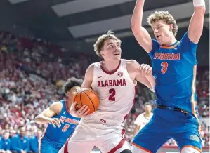  ?? (AP photo/vasha Hunt) ?? Alabama forward Grant Nelson (2) drives Wednesday against Florida center Micah Handlogten (3) during an NCAA college basketball game in Tuscaloosa, Ala.