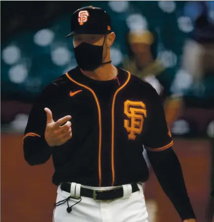  ?? NHAT V. MEYER — STAFF PHOTOGRAPH­ER ?? Giants manager Gabe Kapler has been leading by example by wearing a face mask most of the time he is with his team.