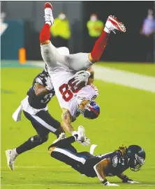  ?? MITCHELL LEFF/ GETTY IMAGES ?? Evan Engram of the New York Giants flips in action against the Philadelph­ia Eagles on Thursday. The Giants are 1-6.