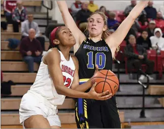  ?? BEN HASTY - READING EAGLE ?? Albright’s Dejah Terrell drives by Widener’s Kyra Schenk during the Lions’ win Wednesday night.