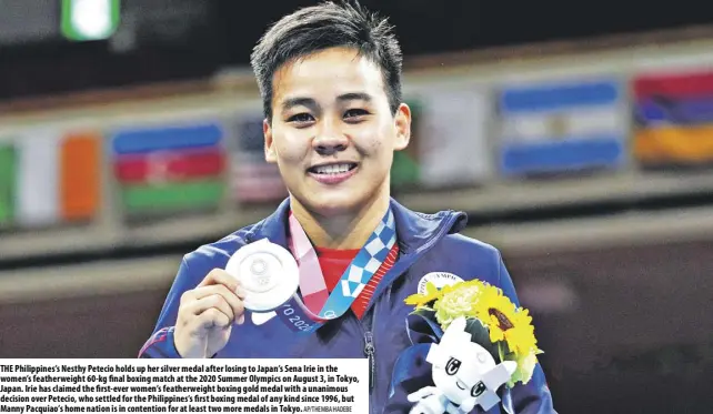  ?? Ap/themba hadebe ?? The Philippine­s’s nesthy Petecio holds up her silver medal after losing to Japan’s sena Irie in the women’s featherwei­ght 60-kg final boxing match at the 2020 summer Olympics on august 3, in Tokyo, Japan. Irie has claimed the first-ever women’s featherwei­ght boxing gold medal with a unanimous decision over Petecio, who settled for the Philippine­s’s first boxing medal of any kind since 1996, but Manny Pacquiao’s home nation is in contention for at least two more medals in Tokyo.