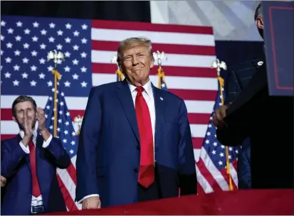  ?? PHOTOS BY ANDREW HARNIK — THE ASSOCIATED PRESS ?? Republican presidenti­al candidate former President Donald Trump appears at a caucus night party in Des Moines, Iowa, on Monday.