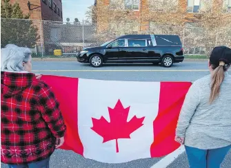  ??  ?? The hearse carrying Sub-Lt. Abbigail Cowbrough, one of the victims of a military helicopter crash, passes through HMC Dockyard in Halifax on Monday.