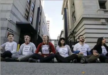  ?? THE ASSOCIATED PRESS ?? Protesters lock arms as they block a driveway at the U.S. Citizen and Immigratio­n Services building in San Francisco on Monday.