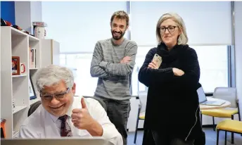  ?? ?? Detroit Free Press Editor Peter Bhatia, Brian Kaufman and Kathy Kieliszews­ki listen to a conference call while celebratin­g after the Pulitzer announceme­nts on Monday, April 16, 2018. (Photo credit: Ryan Garza, Detroit Free Press)