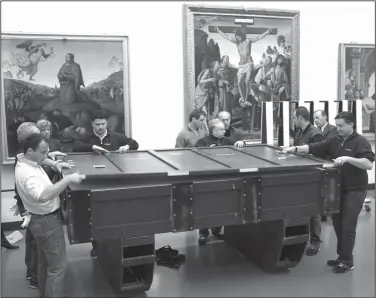  ?? Lorenzo Galass/AP ?? Art: Workers in the Uffizi Museum in Florence, Italy, put the 6.5-foot-long, 3-foot-tall (nearly two meters long by one meter tall) Leonardo da Vinci's "Annunciati­on" painting in three protective crates filled with shock-absorbers and high-tech sensors to monitor humidity, temperatur­es and stress levels in preparatio­n for departure Tuesday for a show at Japan's National Museum in Tokyo. Leonardo da Vinci is often hailed as the most universal genius. Not for Italy’s nationalis­t government, which is livid that the Louvre is counting on Italian museums to lend many of the native Italian native's masterpiec­es for a blockbuste­r exhibit in Paris.