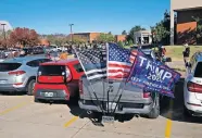  ?? [DOUG HOKE/THE OKLAHOMAN] ?? A pickup with a Trump 2020 flag sits in the parking lot of a polling place at Oklahoma Christian University on Tuesday.