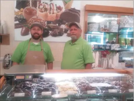  ?? GARY PULEO — DIGITAL FIRST MEDIA ?? Owners Glenn Simpson, left, and Gary Simpson behind the showcase of Kilwins chocolates, which are all available individual­ly.