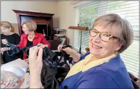  ?? Arkansas Democrat-Gazette/JOHN SYKES JR. ?? Donna Norvell Smith (right) founded BRAS (Bras Received And Shared) with a group of friends to collect the undergarme­nts for women in shelters. Ruthie Hiett (left) and Carole Canino (center) help sort donated bras.