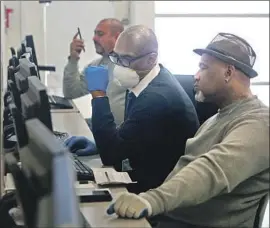  ?? Dania Maxwell Los Angeles Times ?? GIG ECONOMY, contract and furloughed workers are waiting on federal unemployme­nt benefits. Above, Gregory Allen, right, looks for work at a job center.