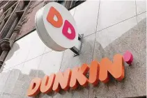  ?? Michael Dwyer/Associated Press ?? The Dunkin’ logo on a storefront in Boston. Reward programs have long been a way for brands to build loyalty and incentiviz­e spending, but now some companies are becoming a bit more stingy, and customers are taking notice. Last fall, for example, many balked at Dunkin’s decision to stop offering a free drink on their birthday and instead give them triple loyalty points on their purchase.