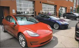  ?? Spencer Platt Getty Images ?? TESLA said Monday night it will release third-quarter results and hold a conference call Wednesday afternoon. Above, a Tesla showroom in Brooklyn.