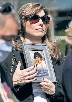  ??  ?? TRUE TOLL: Protesters, including some holding photos of lost loved ones, gather at a makeshift memorial in Cobble Hill on Sunday to honor nursing-home residents who died in the pandemic and to denounce Gov. Cuomo over his administra­tion’s coverup of the facilities’ death toll.