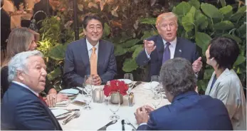  ?? NICHOLAS KAMM, AFP/GETTY IMAGES ?? President Trump, Japanese Prime Minister Shinzo Abe, his wife, Akie, first lady Melania Trump and Robert Kraft, owner of the New England Patriots football team, sit down for dinner at Trump’s Mar-a-Lago resort in Florida on Feb. 10.