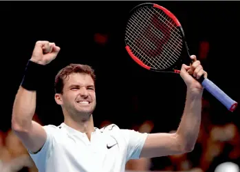  ??  ?? Bulgaria’s Grigor Dimitrov celebrates after beating David Goffin of Belgium at the ATP World Finals at the O2 Arena in London on Wednesday. Dimitrov won 6-0, 6-2.