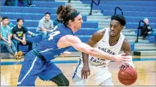  ?? Photo courtesy of JBU Sports Informatio­n ?? John Brown junior Marquis Waller, right, handles the ball while Southweste­rn Christian’s Austin Lobo defends during Thursday’s game at Bill George Arena.