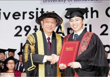  ??  ?? Prof Datuk Dr Paul Chan Tuck Hoong conferring the Bachelor of Business (Accounting) degree on Ong at HELP University’s 30th Convocatio­n.