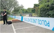  ?? [AP PHOTO] ?? A British police officer guards a cordon Wednesday outside the Queen Elizabeth Gardens park in Salisbury, England. British counterter­rorism police are investigat­ing Wednesday after two people were left in critical condition, exposed to an unknown...