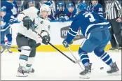  ?? EVAN BUHLER — THE CANADIAN PRESS ?? Sharks forward Logan Couture (39) shoots the puck between the legs of Maple Leafs defenseman Justin Holl (3) during the first period on Friday in Toronto.