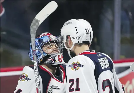  ?? JASON KRYK ?? Spitfires goalie Michael DiPietro, left, celebrates with Logan Brown after the Spitfires defeated the Seattle Thunderbir­ds 7-1 Sunday. Despite being underdogs as the host team, Windsor, along with Erie, has dominated the Memorial Cup so far. The two...