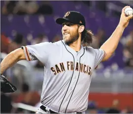  ?? MARK BROWN — GETTY IMAGES ?? Giants pitcher Madison Bumgarner delivers to the plate in the first inning of Tuesday’s 9-4 win over the Miami Marlins at Marlins Park. Bumgarner picked up the win after going six innings with four runs allowed on four hits with four strikeouts.