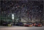  ?? (AP/Mark Humphrey) ?? Cars run during the NASCAR Cup Series All-Star Race on Wednesday at Bristol, Tenn. The track was allowed to sell up to 30,000 tickets for the race and Texas Motor Speedway has been allowed to admit up to 67,500 spectators for Sunday’s race. Iowa Speedway, which is owned by NASCAR, will allow up to 60,000 fans for this weekend’s IndyCar race.