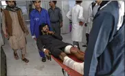  ?? RAHMAT GUL / ASSOCIATED PRESS ?? Afghans carry a wounded man into a hospital after a suicide attack Tuesday in northern Parwan province, Afghanista­n.