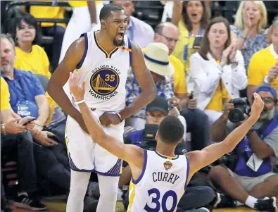  ?? MARCIO JOSE SANCHEZ / AP ?? Golden State Warriors’ Kevin Durant and Stephen Curry celebrate Sunday’s 132-113 victory over the Cleveland Cavaliers in Game 2 of NBA Finals in Oakland, California. Golden State leads the best-of-seven series 2-0.