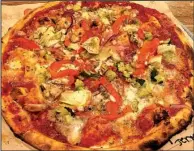  ?? Arkansas Democrat-Gazette/JENNIFER CHRISTMAN ?? Requested artichokes and roasted red peppers accent the Veg Out pizza, a Blaze Pizza signature pie that features zucchini, mushrooms, red onion, mozzarella­ella and red sauce.