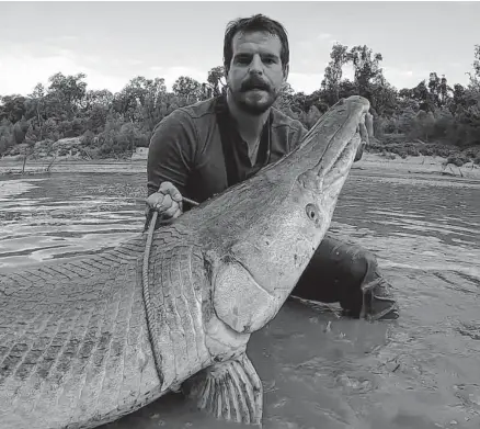  ?? Courtesy of Payton Moore ?? Payton Moore, who is a profession­al Youtuber and angler, caught an alligator gar that was over 8 feet long in one of Houston's waterways. Moore catches and releases the freshwater fish species on his Youtube channel.