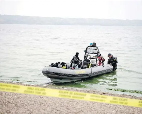  ?? TROY FLEECE ?? RCMP divers were on hand Monday at B-say-tah Point on Echo Lake to assist in the search for missing seven-year-old Greagan Geldenhuys. The body of his mother, Tamaine, 47, was found Saturday near the campground at Fort Qu’appelle. The search has now become a recovery mission.