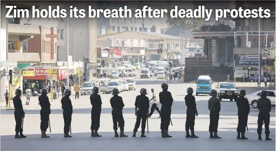  ?? Picture: Reuters ?? WATCHING. Police yesterday cordon off a street during a raid on the headquarte­rs of the opposition Movement for Democratic Change, a day after post-election clashes between security forces and opposition protesters in Harare, Zimbabwe.