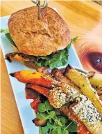  ??  ?? Magic Mushroom Burger — sweet potato and black bean patty on gluten-free bun.