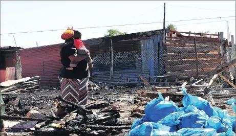  ?? Picture: BHEKI RADEBE ?? AFTERMATH: A mother allegedly tried to kill herself and her two children by burning their shack. She survived with one of her kids.