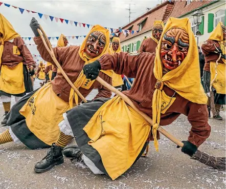  ??  ?? Revellers dressed as witches take part in the annual Fasnet carnival parade this week in Oberdischi­ngen, southern Germany.