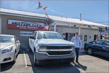  ?? HEATHER CHAPIN —T HE MORNING JOURNAL ?? Sam Saher stands outside his dealership in Lorain