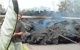  ?? JAMM AQUINO/THE STAR-ADVERTISER VIA AP ?? This surfboard will survive to ride the waves again as residents gathered their belongings Monday in Pahoa, Hawaii.