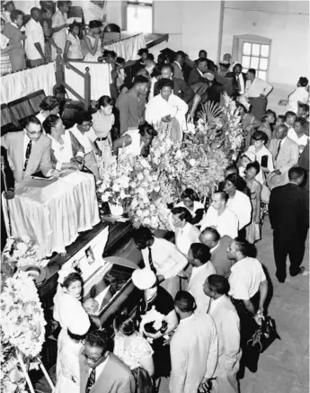  ?? AP FILE PHOTO ?? ABOVE: Mourners pass the casket during the funeral Sept. 6, 1955, for 14-year-old Emmett Till at Roberts Temple Church of God in Christ.